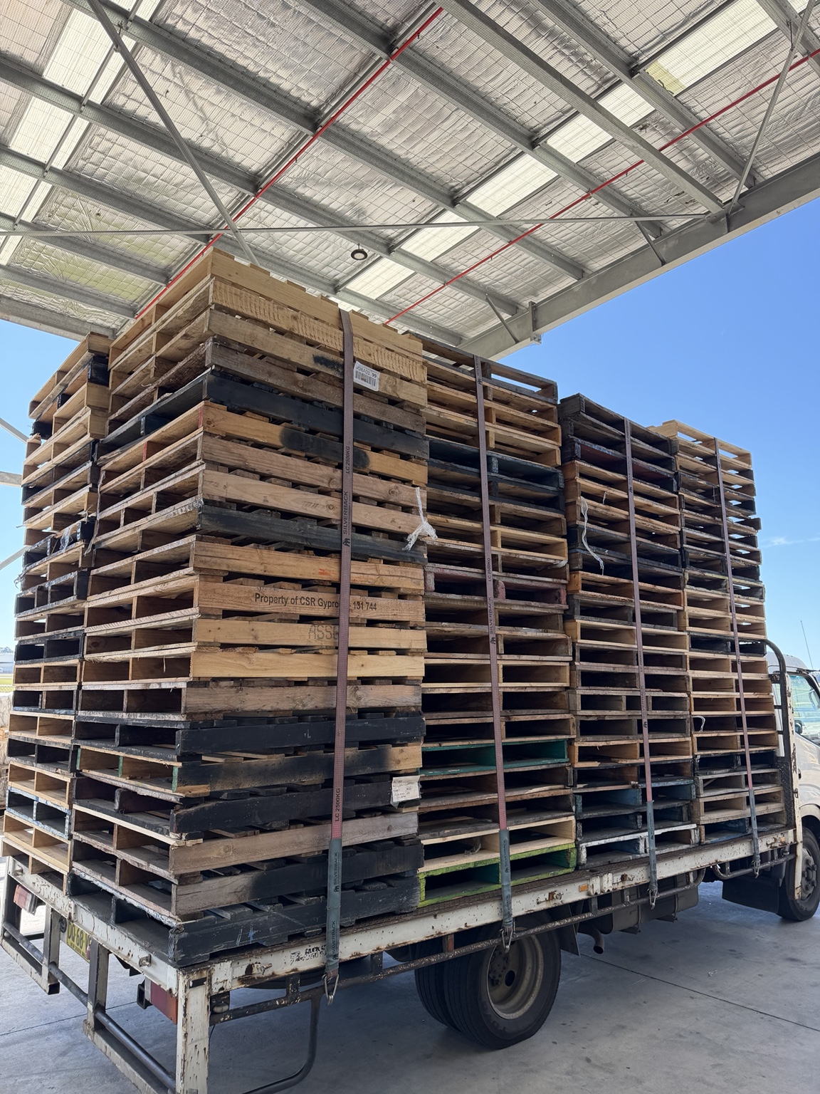 Truck loaded with collected timber pallets